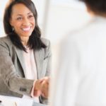 Business woman at a desk shaking hands with a colleague. Click to learn more about how Bank of Nevada is helping attorneys and law firms with their distinct banking needs.